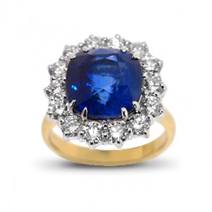 A cushion cut Sapphire weighing 6.97 carats set with diamonds in 18K white and yellow gold