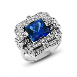 A cushion cut Tanzanite weighing 6 carats set with diamonds in 18K white gold