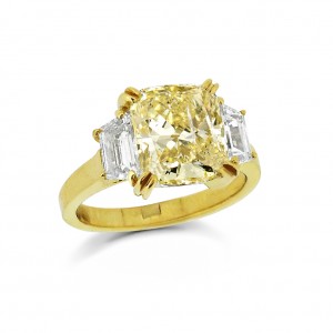 A Cushion cut yellow diamond with white tapered baguette diamonds.