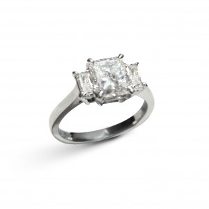 A 1.50 carat G VS1 Radiant cut diamond with faceted Baguettes mounted in 18K white gold 