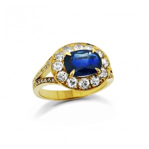 An Oval sapphire mounted in 18k yellow gold with G VS quality diamonds